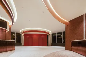 Modern lobby featuring a combination of terrazzo flooring and metallic accents.