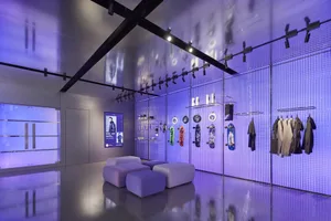 A modern retail shop with a glass wall and metal accents.