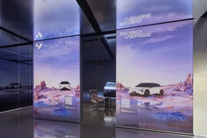 Digital display showcasing a futuristic car launch event with a dark conceptual design.
