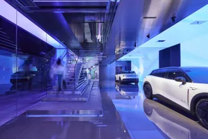 Automotive exhibition showcasing modern interiors with glass and metal materials.