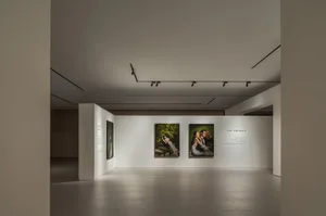 Photography exhibition in a modern space with white walls and minimalistic design.