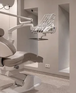 White leather dentist's chair and metal equipment in a modern dentist office
