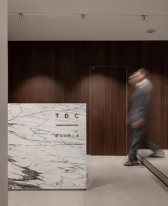 A minimalist, modern office design featuring a marble reception counter.