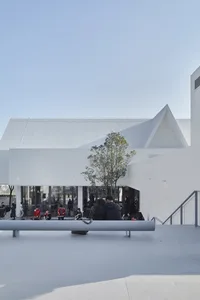 Modern public space with concrete and glass elements.