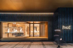 An elegant, modern storefront with glass windows and concrete elements.