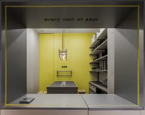 A minimalist display case with a metallic frame and a yellow background.