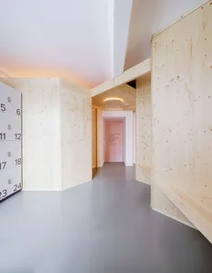 Minimalist interior space featuring wooden and concrete elements.