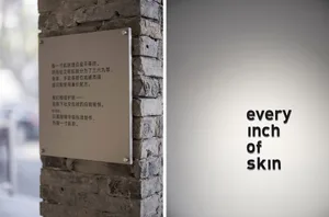 極簡金屬文字招牌安裝在磚牆上。