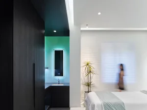 Modern minimalist bedroom featuring light wood and white fabric