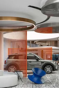 Modern indoor space with cars displayed and contemporary design elements.