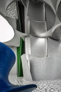 A modern interior design space featuring concrete walls and ceiling.