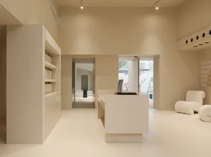 A modern office space with minimalist design, neutral tones, and clean lines.