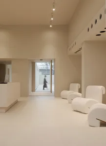 Modern reception area with light-colored terrazzo flooring and minimalist design.