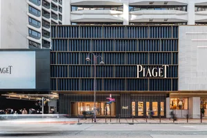 Modern storefront with glass and metallic elements in an urban setting.