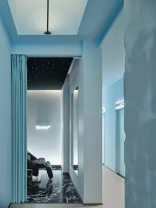 A modern spa suite featuring luxury marble flooring and sleek concrete walls.