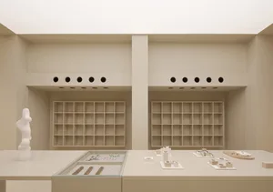 A minimalist retail jewelry shop featuring modern fixtures and shelves with neutral-toned finishes.