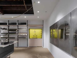 Modern storefront with black shelves, yellow accents, and metal cabinets.