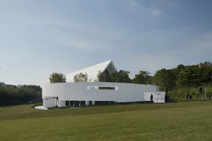Modern building with white stone and concrete exterior.