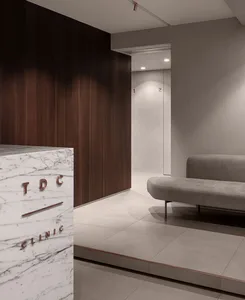 Modern hospitality interior design featuring marble, wood, and concrete materials.