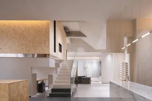 Minimalist living space featuring concrete, wooden and glass material