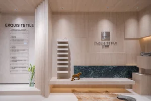 A minimalist interior space featuring marble decor and a clear vase with greenery.