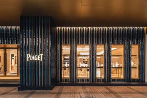 Modern retail storefront featuring glass, metal, and wood elements.