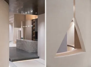 A modern interior design featuring concrete walls and marble surfaces.
