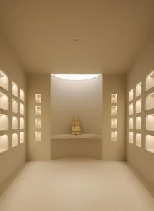Minimalist interior with white walls and candles, creating a serene atmosphere.