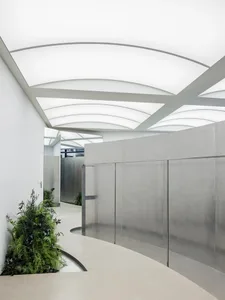 Modern interior featuring glass walls and concrete floors.