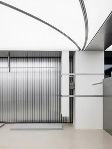 Modern minimalist interior with metallic surfaces and geometric design elements.