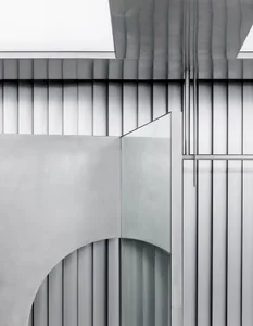 Modern building interior with metallic walls and arches.