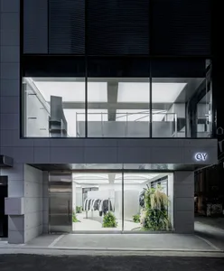 A modern retail storefront with glass walls and minimalist design.
