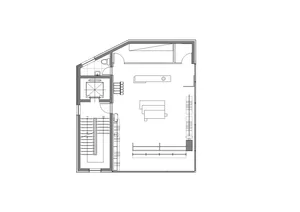 Industrial office space with a technical floor plan drawing, featuring lines and shapes representing furniture and layout.