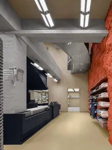 Modern clothing store with concrete walls and a minimalist design.