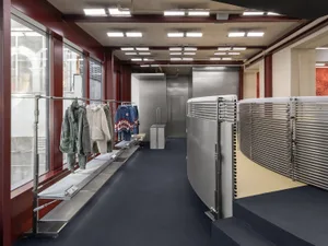 Inside a modern commercial space featuring a clothing retail store with metal elements.