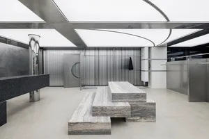 Industrial-style retail storefront with metal elements and concrete floor.