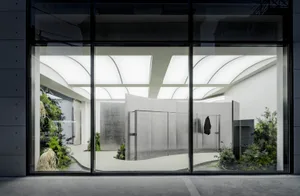 Modern interior space with concrete walls and glass elements