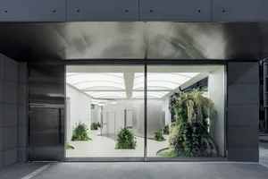 Modern office space featuring glass walls and contemporary design elements.