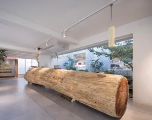 A modern reception desk made of wood in a lobby setting.