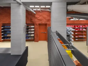 A retail store interior with concrete walls and floors.
