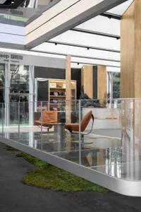 A modern retail storefront featuring glass, wood, and concrete materials.