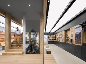 Modern showroom interior with wooden and concrete elements.
