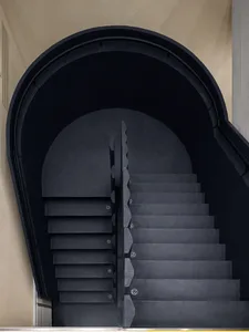 Modern stairs with black metallic steps and a glass railing