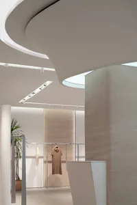 Modern retail store interior with neutral-toned materials and minimalist design.