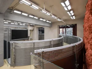 An industrial exhibition hall featuring metallic structures and lighting.