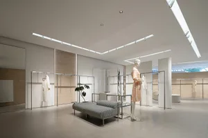 A minimalist retail space with neutral tones and modern fixtures.