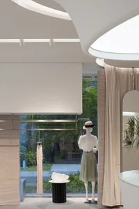 Minimalist storefront with glass window and clothing display.