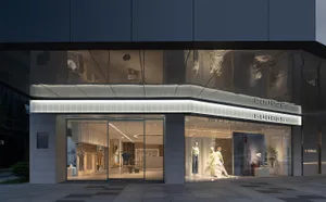 Modern retail storefront with glass facade, showcasing minimalist aesthetic.