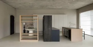A minimalist residential interior with a concrete floor and minimalist furniture.