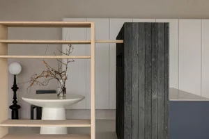 Minimalist interior design featuring wooden shelves and minimalist decor.